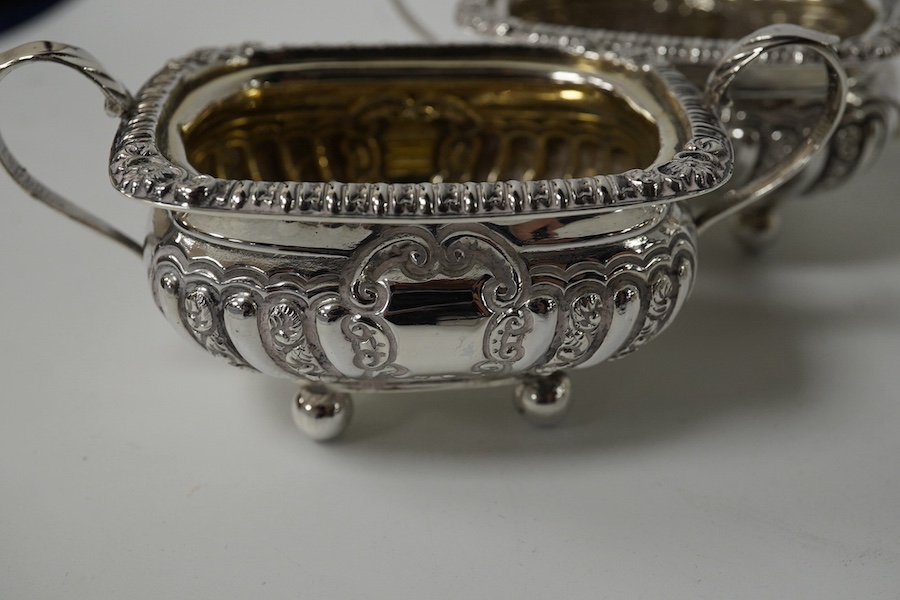 A set of four late Victorian embossed silver two handled salts, Birmingham, 1896, 98mm and a pair of silver peppers. Condition - fair to good